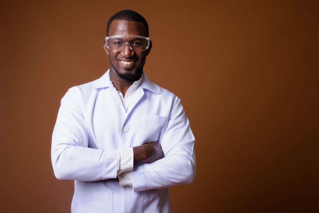 Handsome African man doctor wearing protective glasses